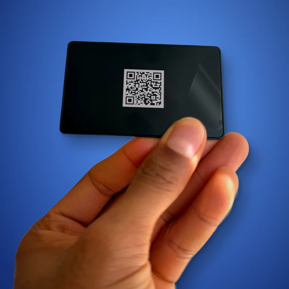 The back of the same metal card, with a QR code